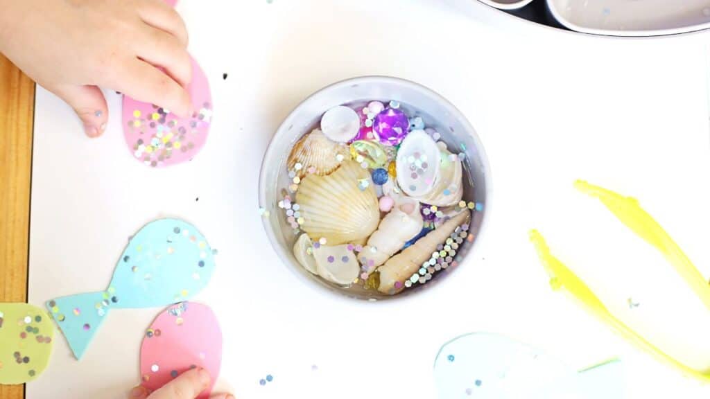 sparkling mermaid sensory bin playing hands.